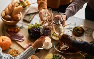 group of friends enjoying holiday dinner and wine