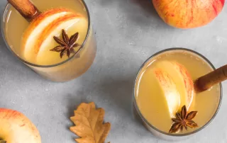 red apple cider with spices in glass cups